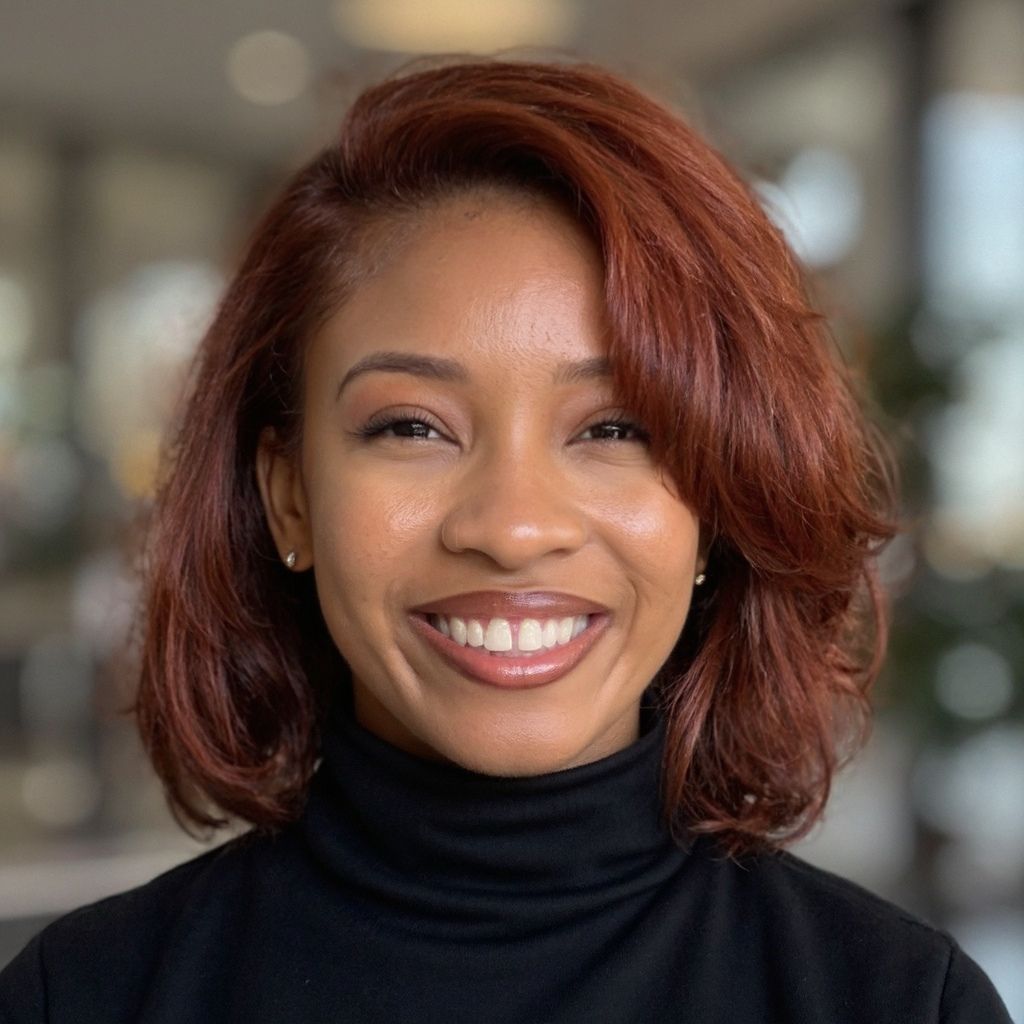 Photo of black woman with short red straight hair smiling